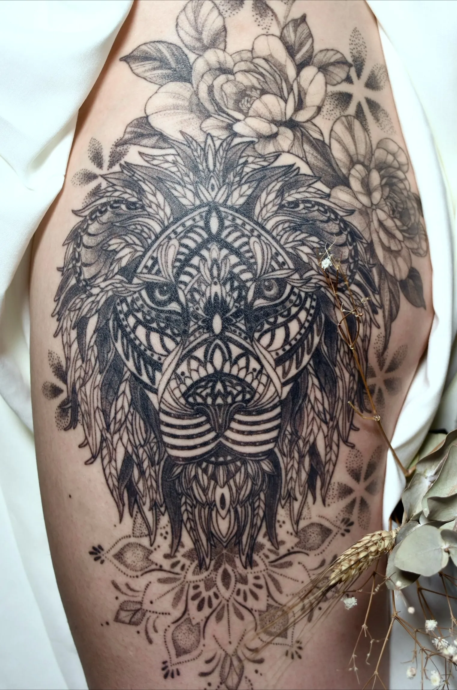 Ornamental tiger thigh tattoo with mandala-inspired patterns, peonies, and black and grey dotwork shading.
